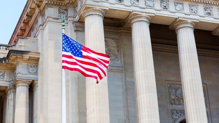 An American flag waving in front of the US Supreme Court