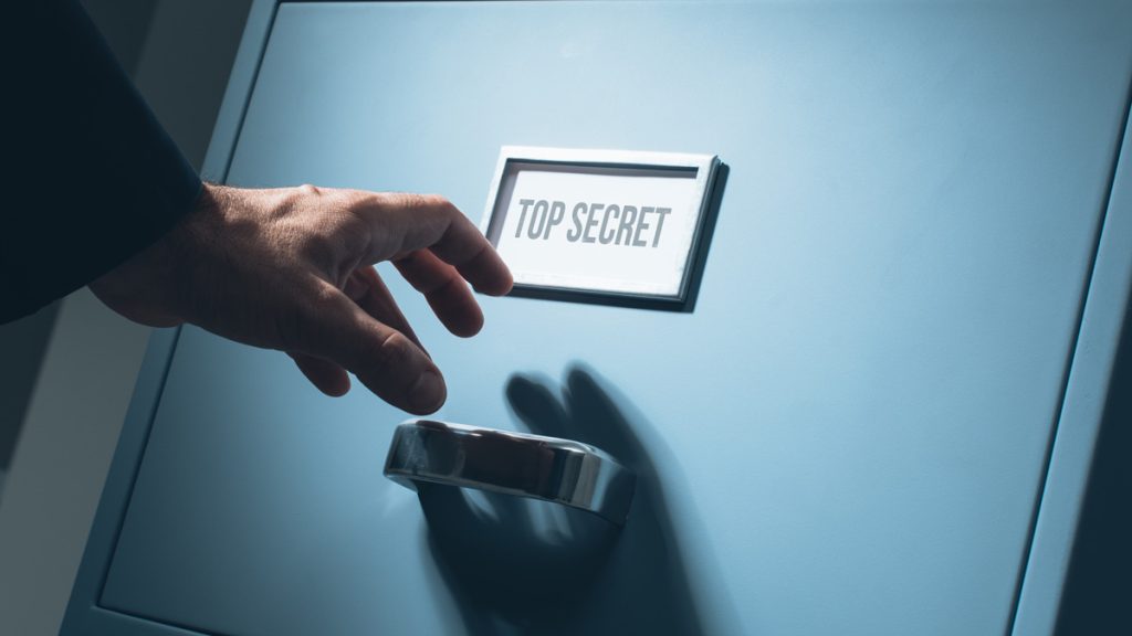 A locked file cabinet with a top secret label on it