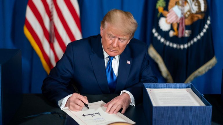 U.S. President Donald Trump signing an executive order during his first days into his second term.