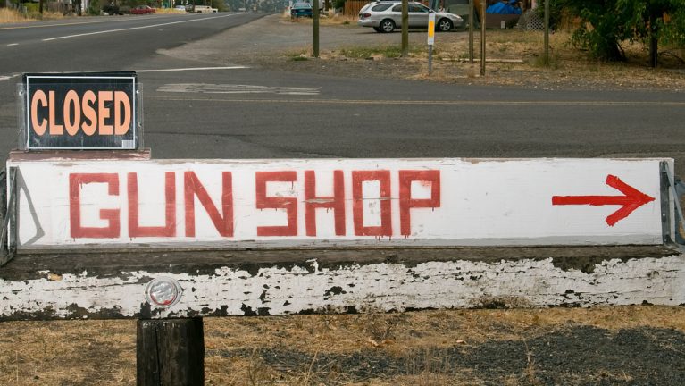 A sign indicated a gun shop is closed