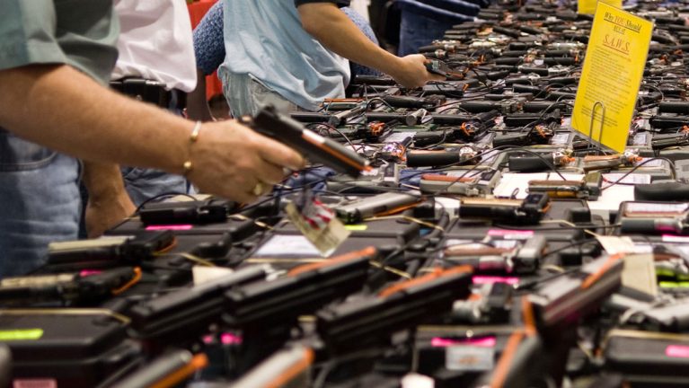 Handguns for sale at a gun show.