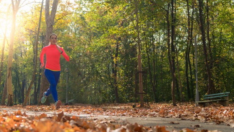 A woman jogging on a trail